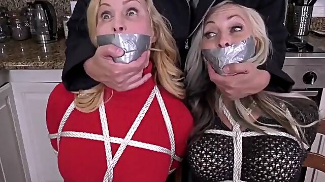 Two milfs in bondage and gagged with duct tape in their boots