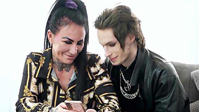 Inked Mature With Big Tits Gives Blowjob To Emo Stud